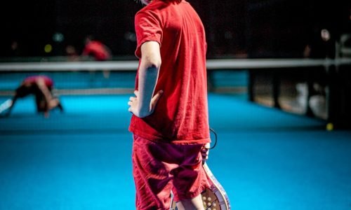 girl in red t-shirt and black pants running on blue floor